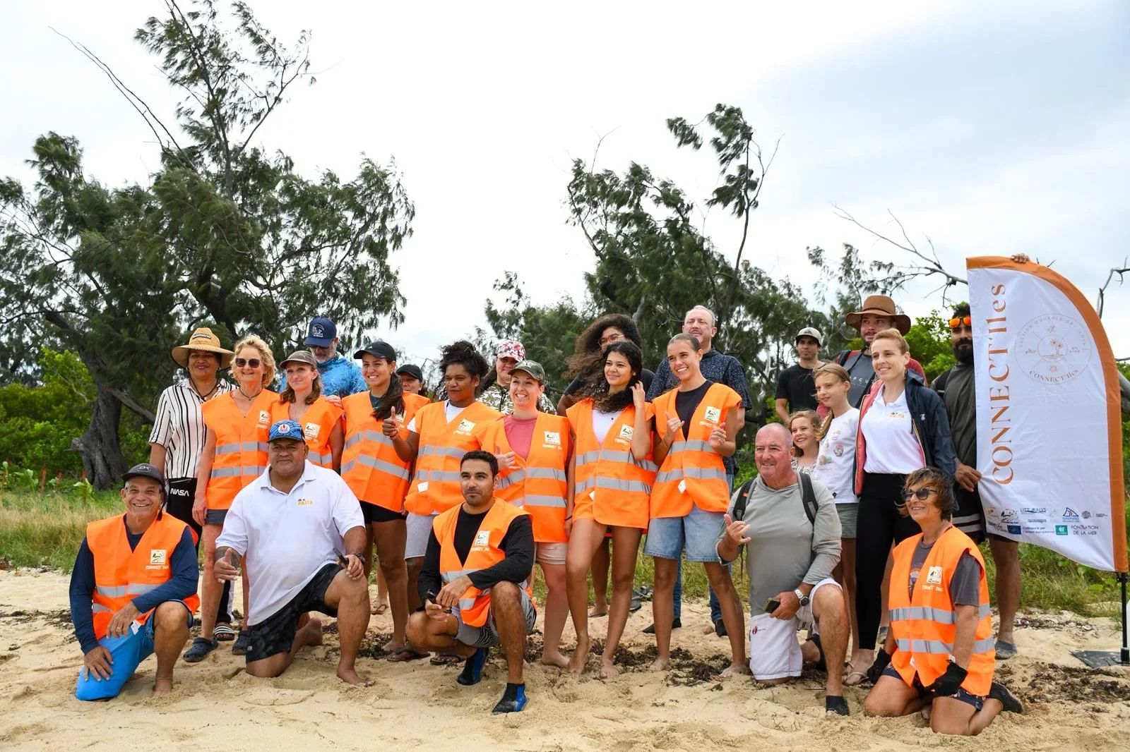 L’équipe des Gardiens des îles réunie sur une plage, sourire aux lèvres